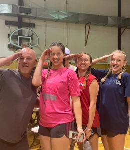 A picture of 4 salkehatchie volunteers posing for a photo. They are all saluting