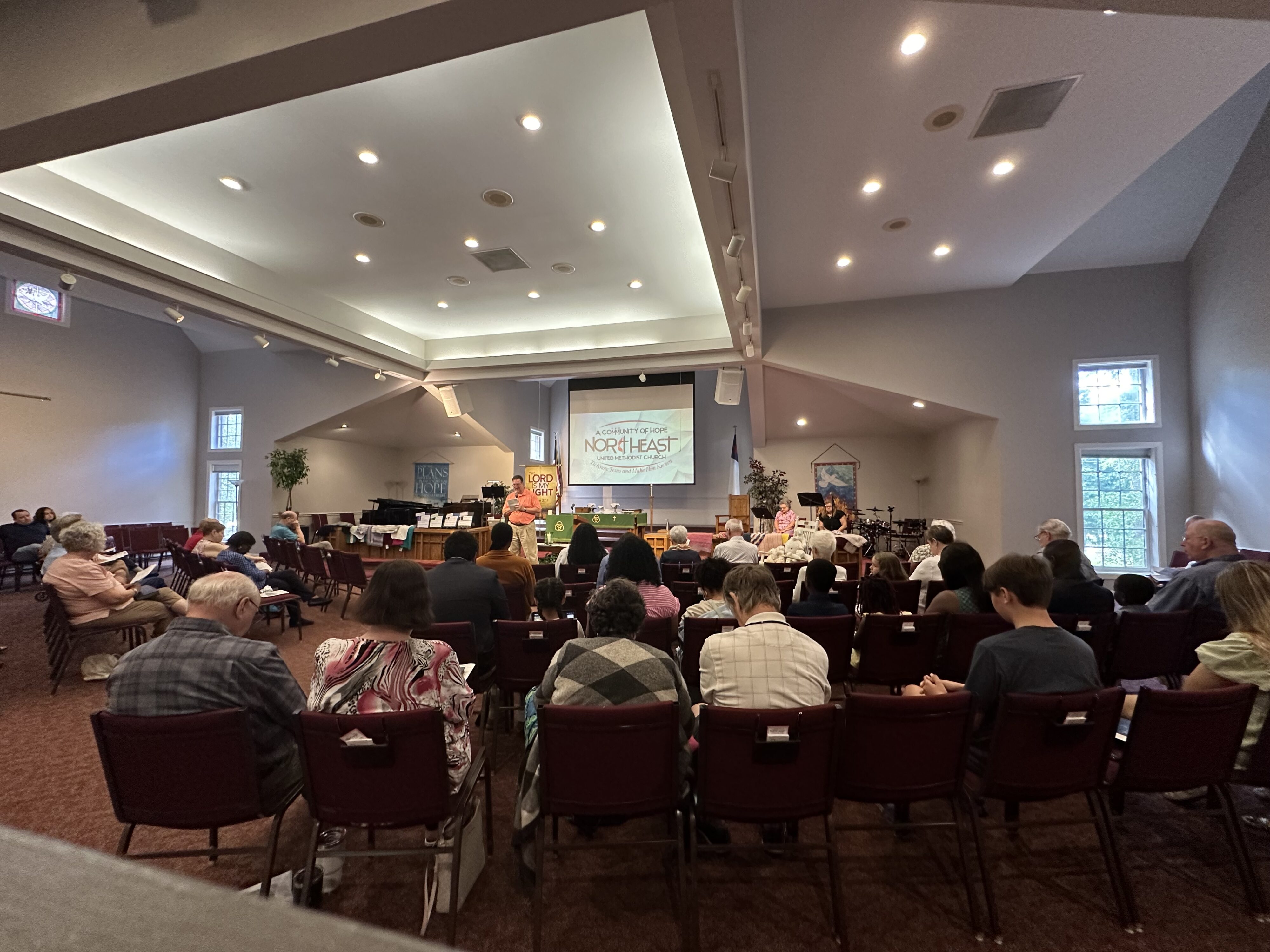 Stephen Crowell prays in front of the congregation during a sunday worship service