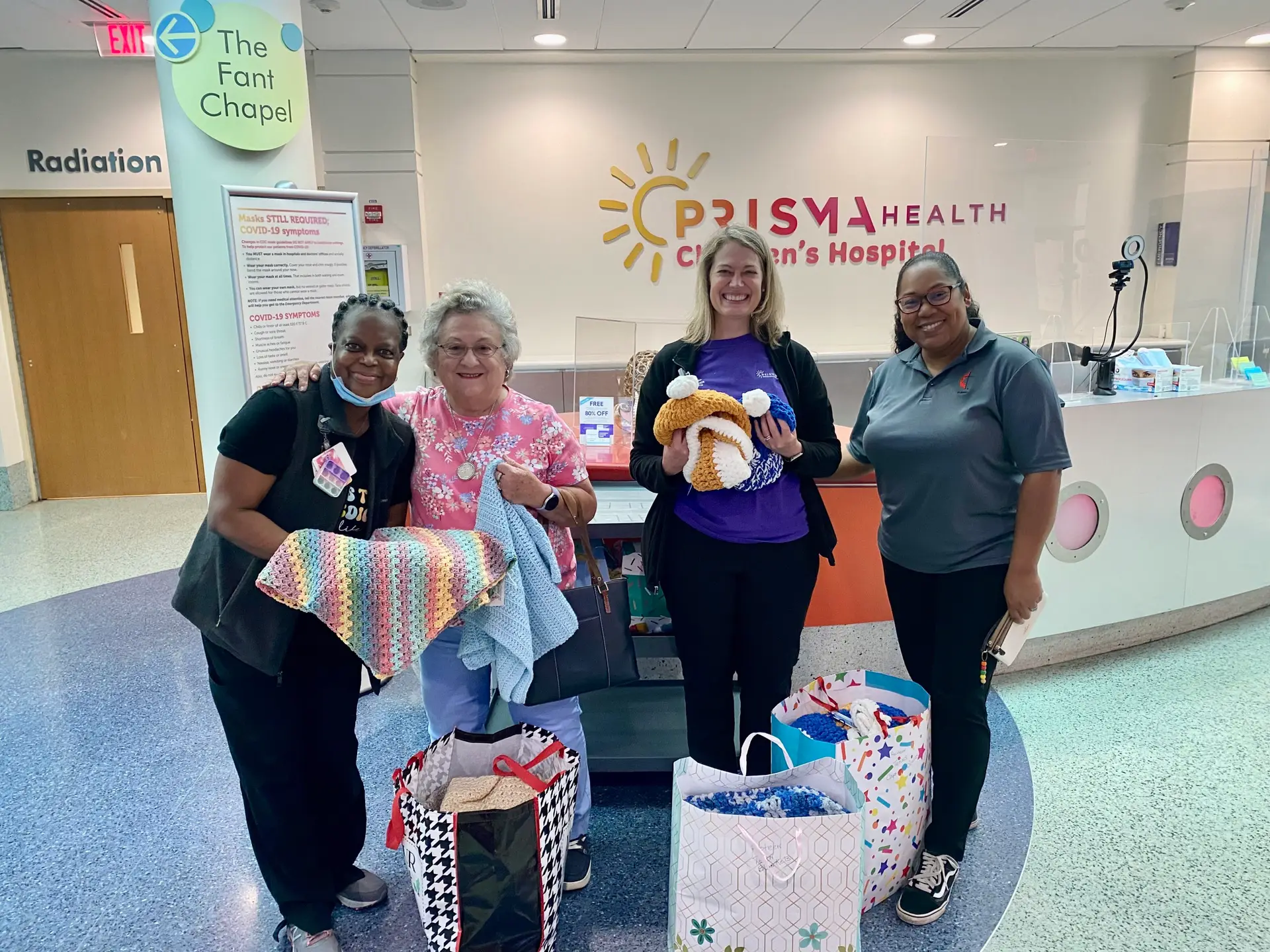 A group of volunteers pose for a photo at Prisma Health after donating prayer shawls.