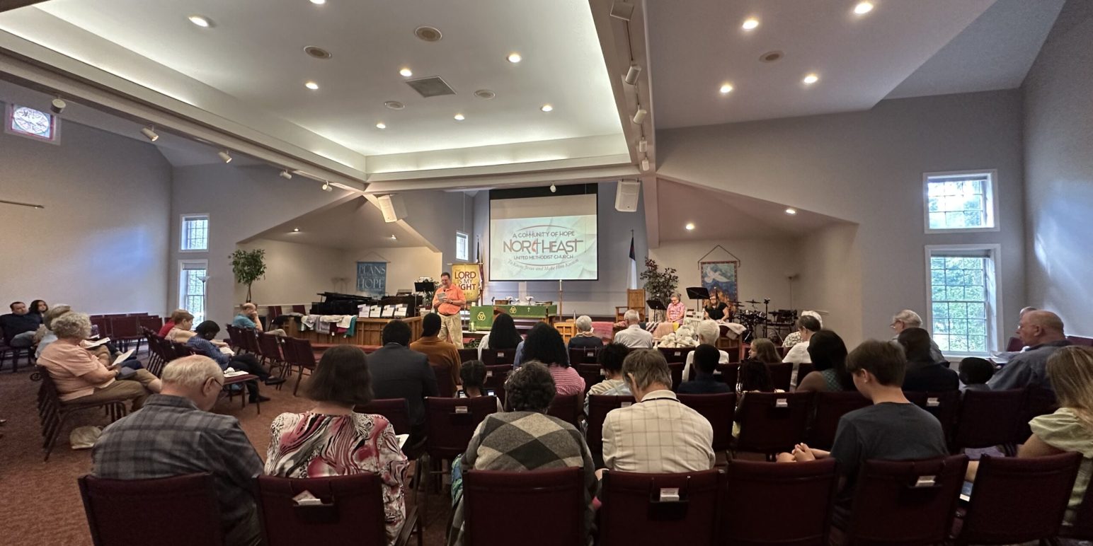 Stephen Crowell prays in front of the congregation during a sunday worship service