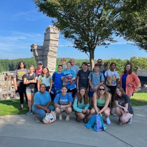 The youth group gathers for a picture at a white water rafting park.